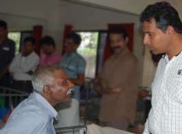 WOH talking with an elderly man